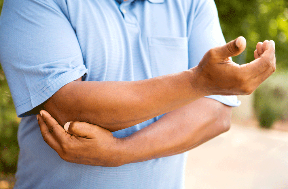 What Is A Natural Remedy For Elbow Pain Greenolivescafephilly   Man Holding Elbow In Pain.ashx